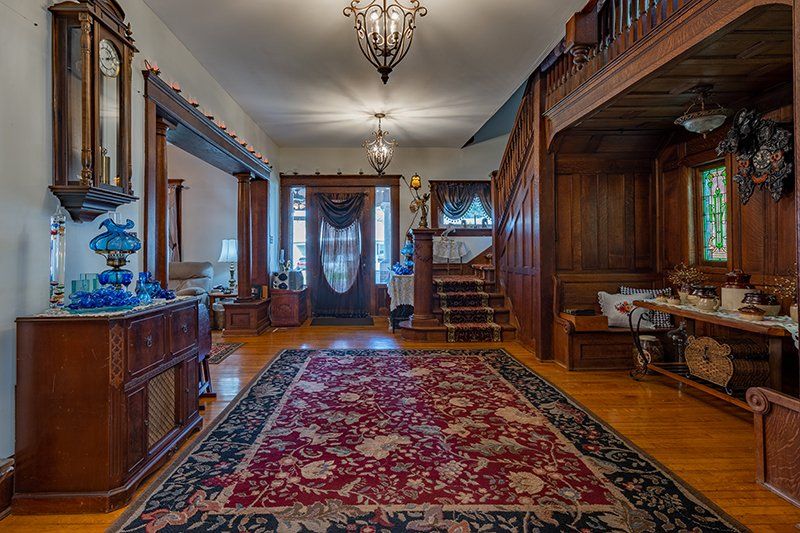There is a large rug in the middle of the hallway.