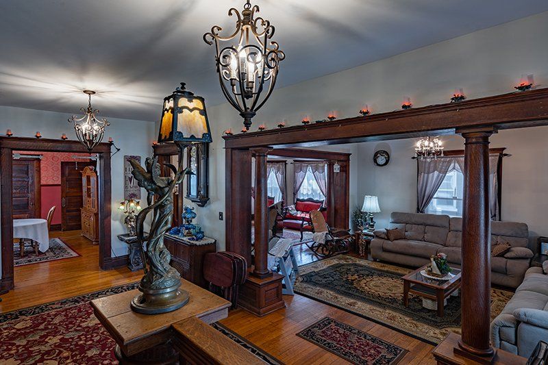 A living room filled with furniture and a statue of a woman.