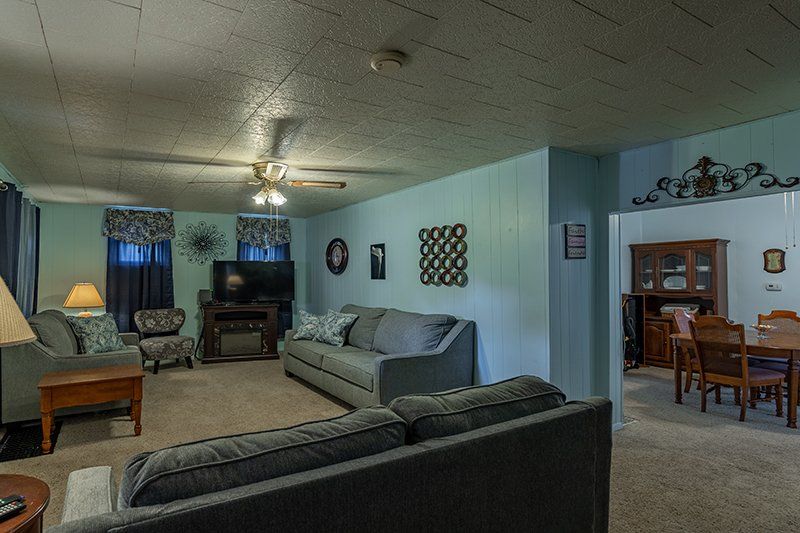 A living room filled with furniture and a ceiling fan.