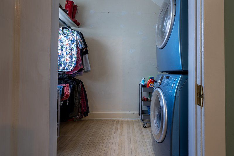 A laundry room with a washer and dryer stacked on top of each other.