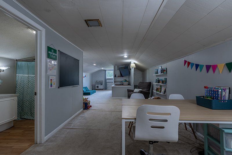 A room with a table and chairs in it.