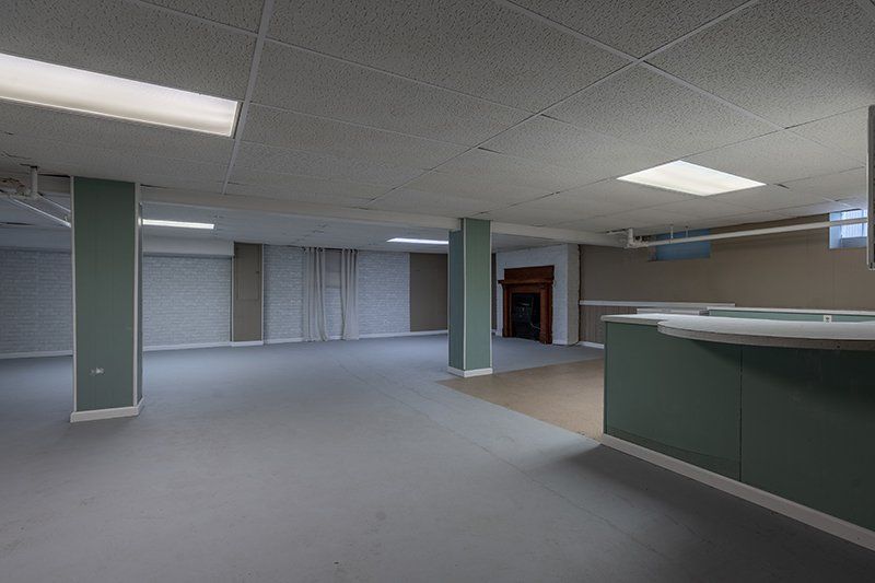 An empty room with a counter in the middle of it