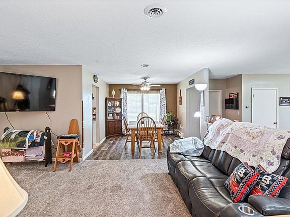 A living room with a couch , table and television.