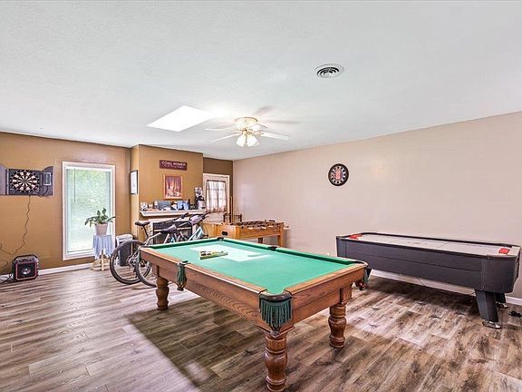 There is a pool table in the middle of the room.