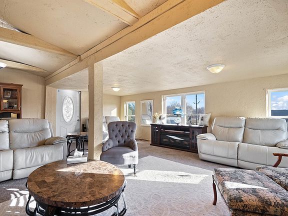 A living room filled with furniture and a round coffee table.