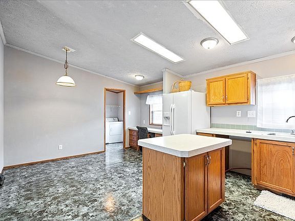 A kitchen with a large island in the middle of the room.