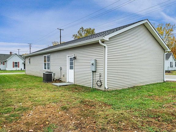 A small house with a garage in the backyard is for sale.