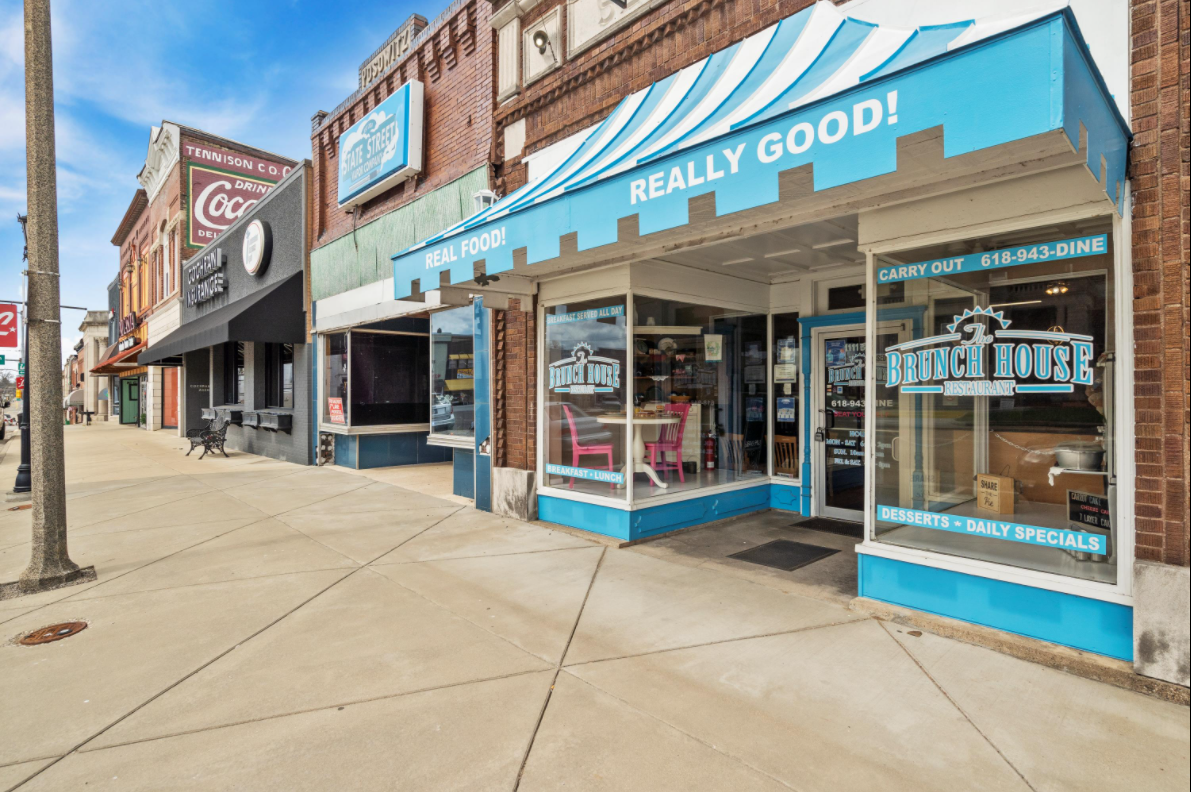 A store front with a blue awning that says `` really good ''.