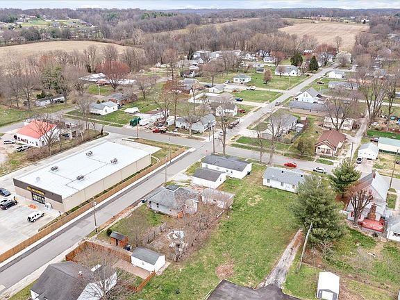 An aerial view of a small town with lots of houses and trees.