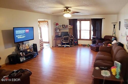 A living room with a couch and a flat screen tv