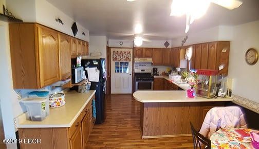 A kitchen with a table and chairs and a refrigerator