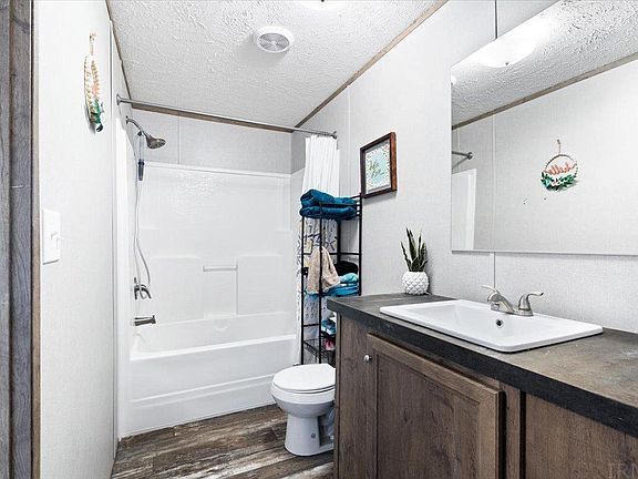 A bathroom with a toilet , sink , and bathtub.