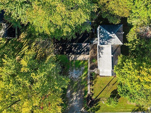 An aerial view of a house surrounded by trees.