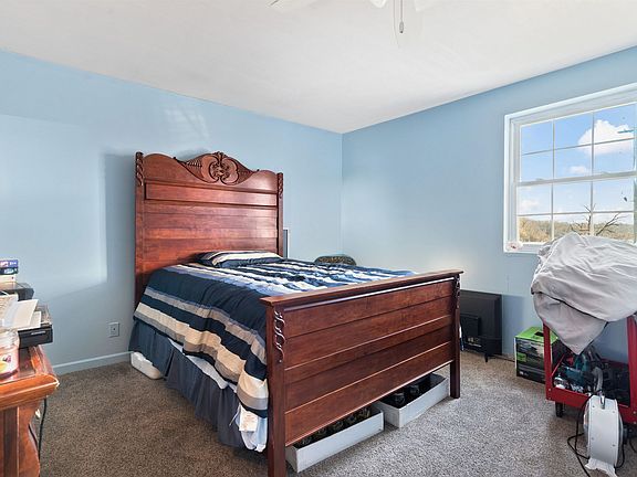 A bedroom with a wooden bed and a window