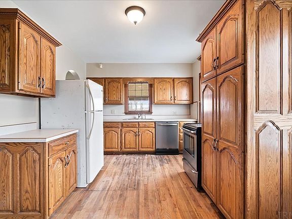 A kitchen with wooden cabinets and stainless steel appliances