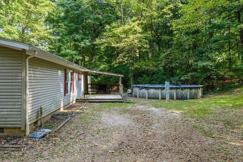 A mobile home is sitting in the middle of a lush green forest.