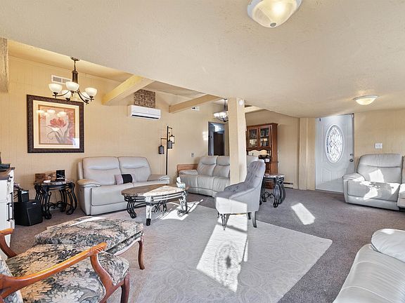 A living room filled with furniture and a chandelier.