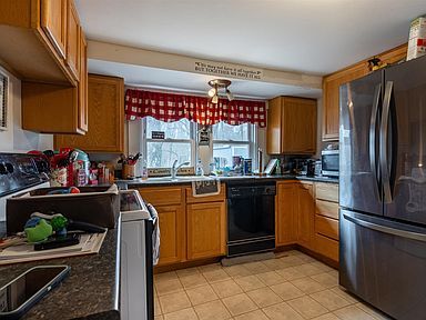 A kitchen with stainless steel appliances and wooden cabinets.