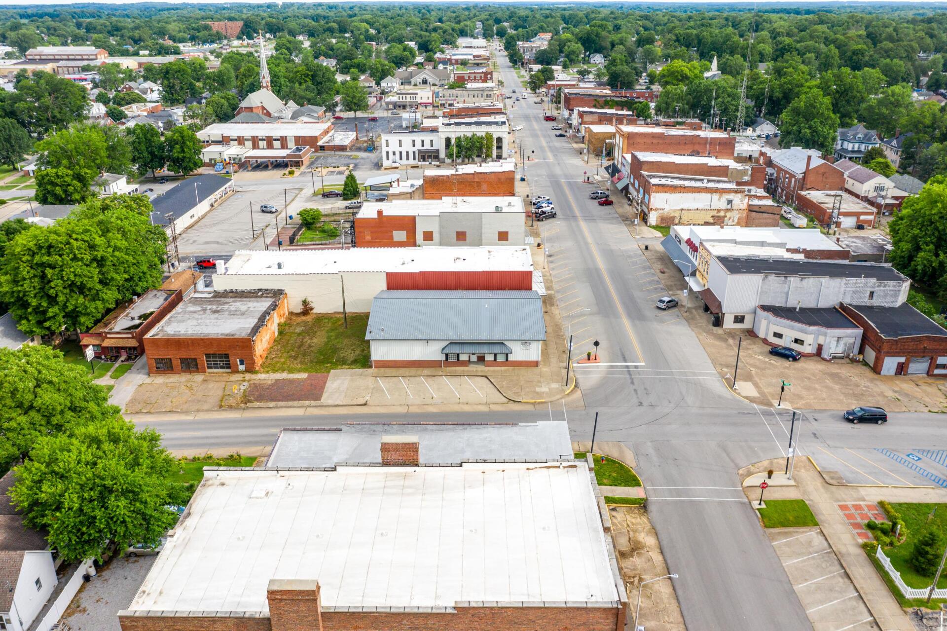An aerial view of a small town with lots of buildings and trees