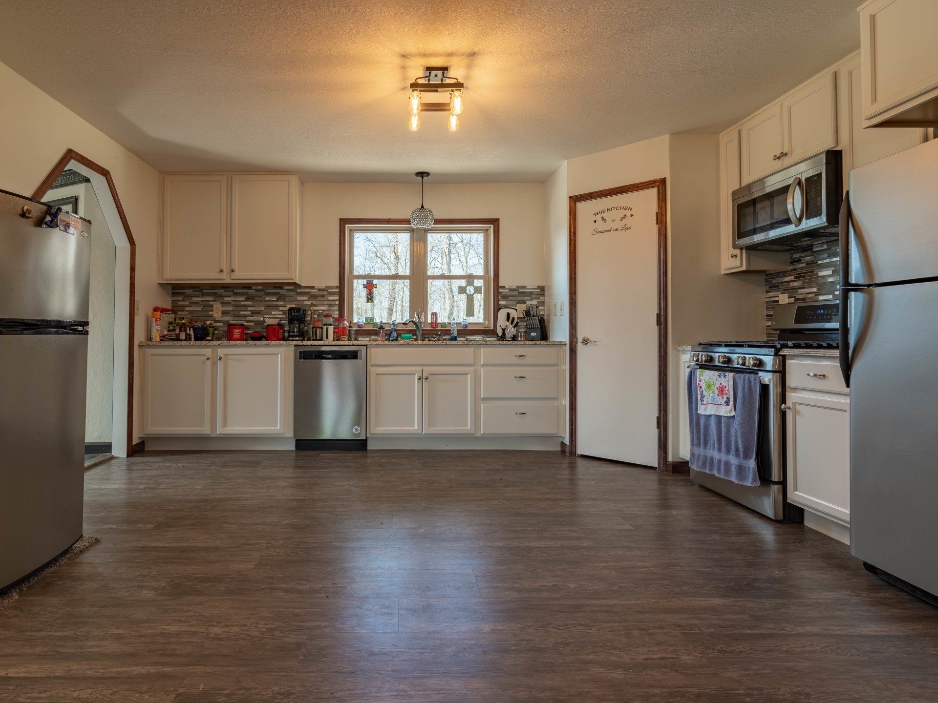 A kitchen with stainless steel appliances and white cabinets