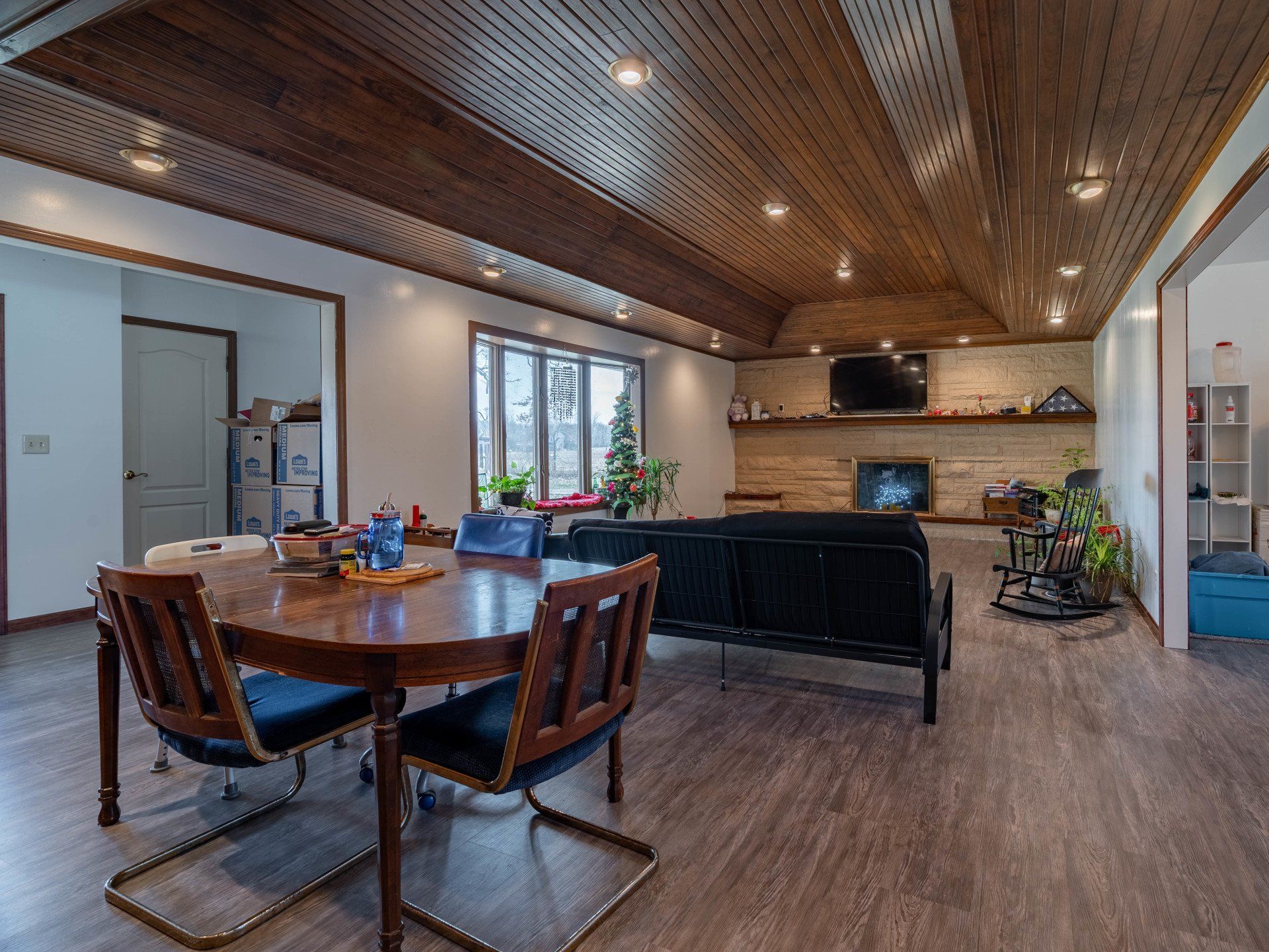 There is a table and chairs in the middle of the room.