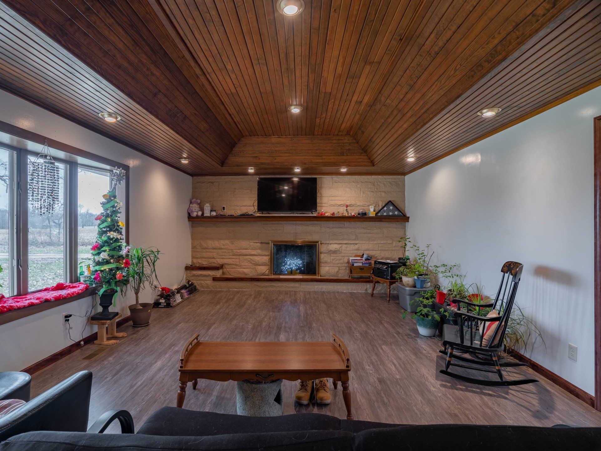 A living room with a fireplace , couch , table and chairs.