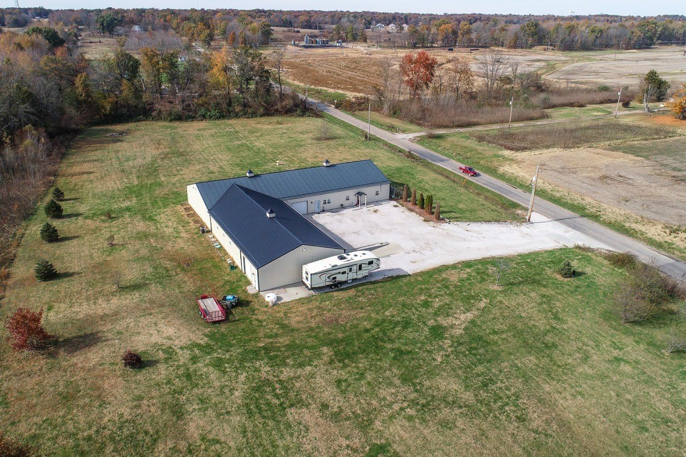An aerial view of a large building in the middle of a field.