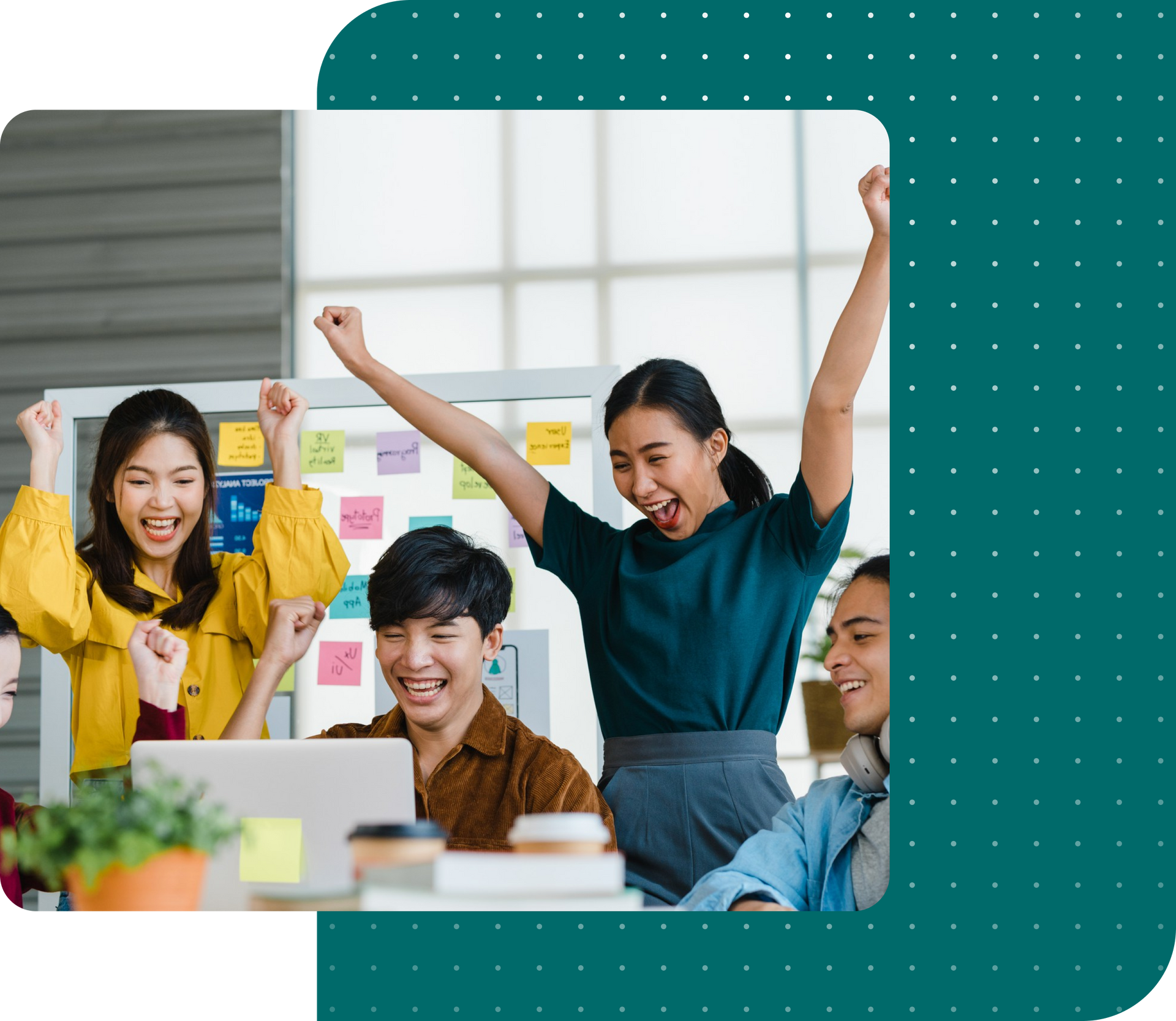 A group of people are sitting around a table with their arms in the air.