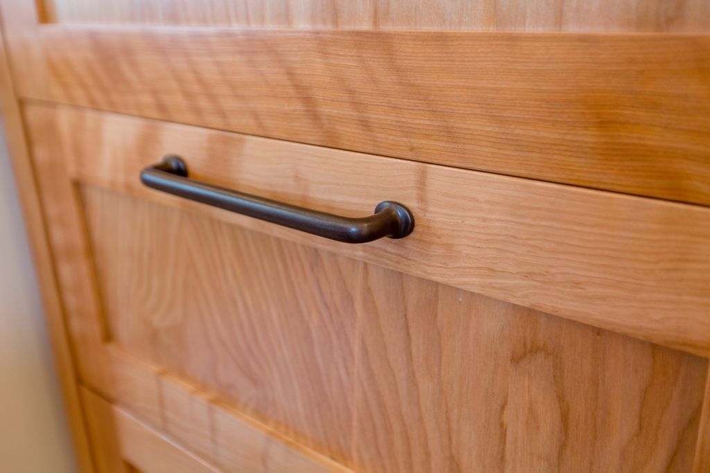 Wooden cabinet with a dark handle.