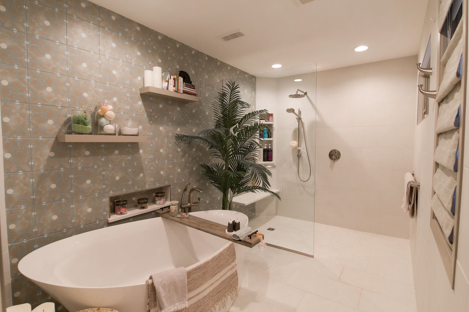 Bathroom with clawfoot tub, toilet, shower, wooden-framed window, and textured wallpaper.