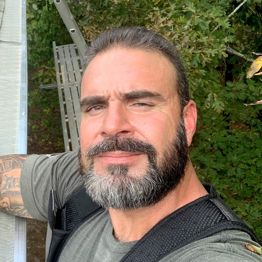 Michael Triska  is standing next to a ladder.