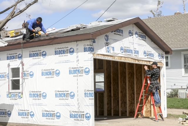 A well-lit empty garage, highlighting the craftsmanship of Sunrise Builders, your trusted garage builder in Cedar Rapids, IA. A well-lit empty garage, highlighting the craftsmanship of Sunrise Builders, your trusted garage builder in Cedar Rapids, IA.