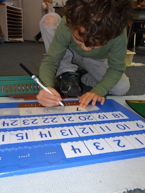 Boy writing numbers - Montessori school in North Bend, WA