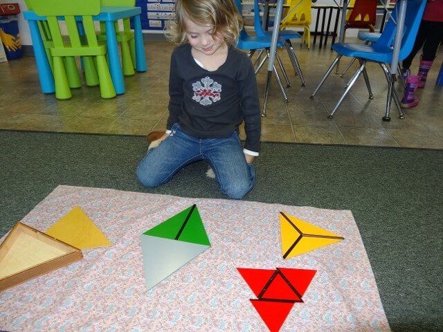 Girl playing triangle puzzles - Montessori school in North Bend, WA