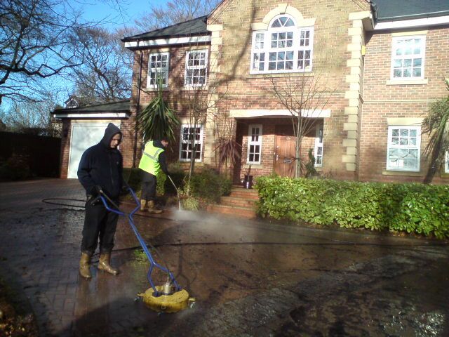 man cleaning driveway