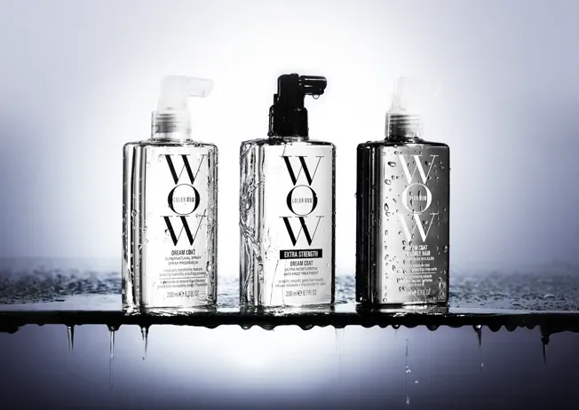 Three bottles of wow hair products are sitting on a table.