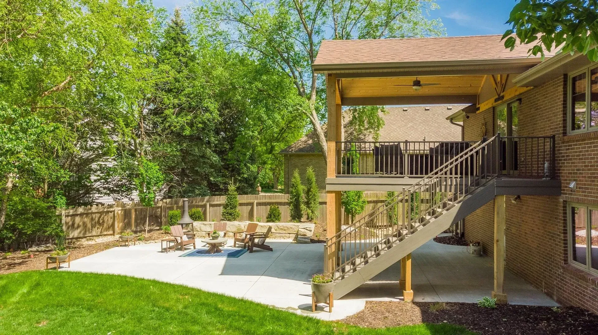 A house with a covered patio and stairs leading up to it.