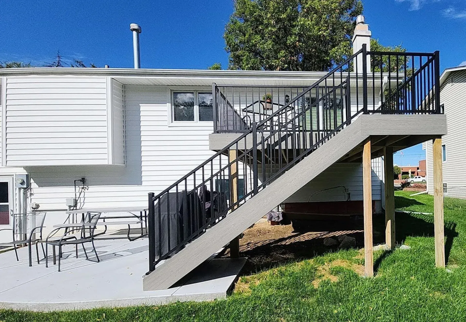 A house with a deck and stairs leading up to it