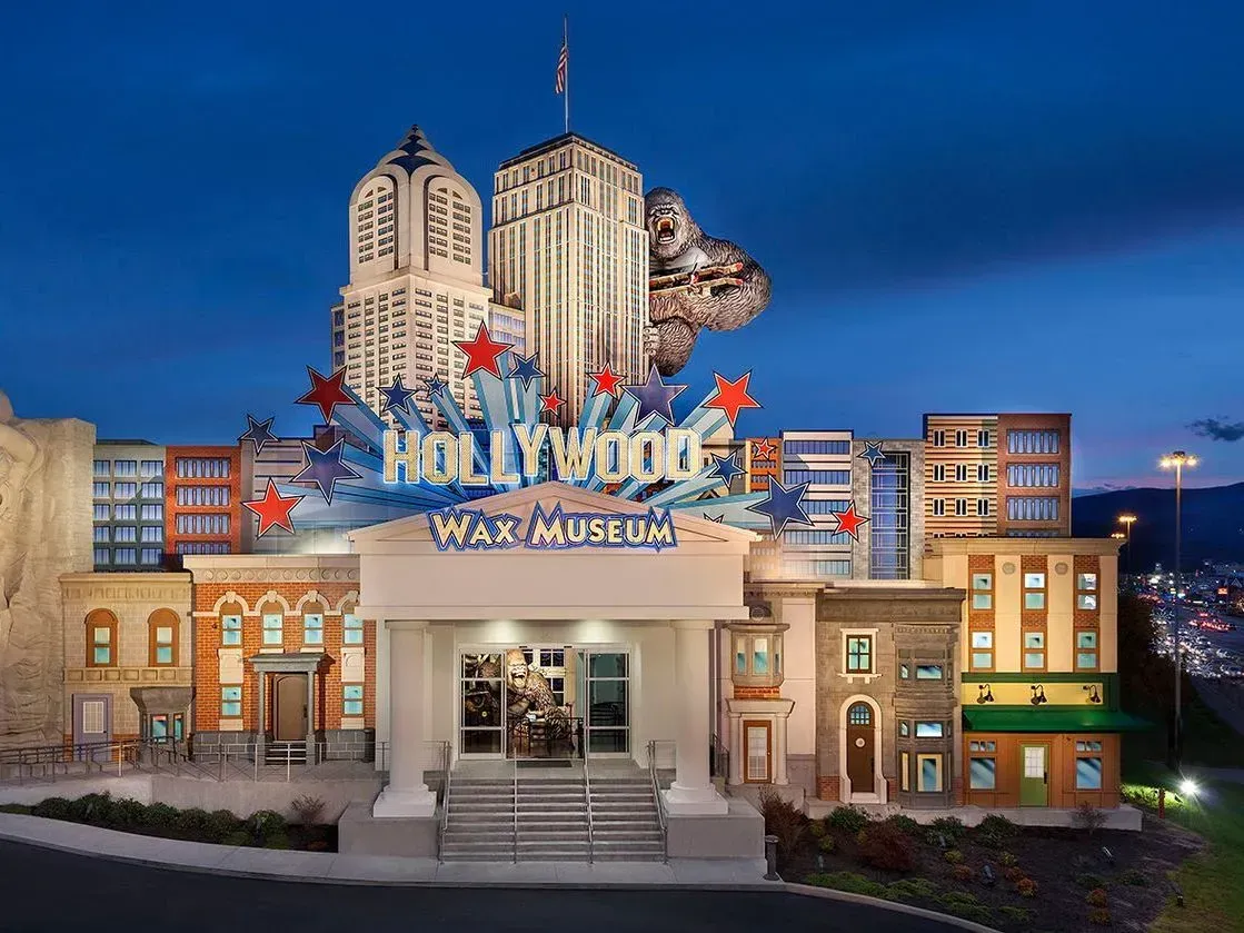 The Hollywood Wax Museum in Pigeon Forge features a building with a movie-themed facade at twilight.