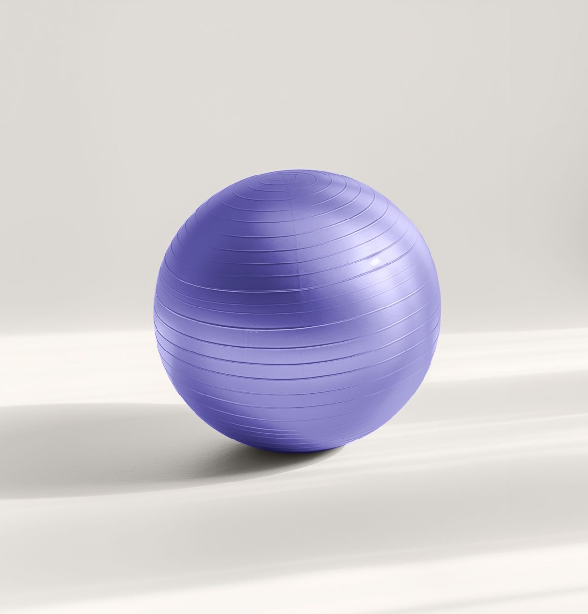 A gold-colored exercise stability ball with horizontal textured lines centered against a plain background.