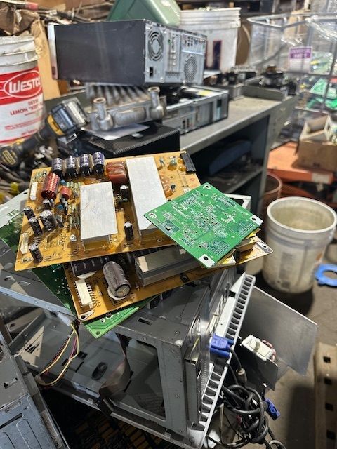 A pile of electronic components including a bucket of lowes oil