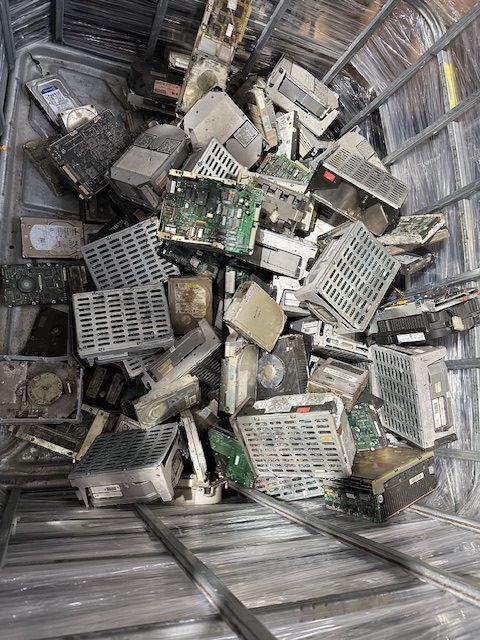A pile of old electronic components in a metal container.