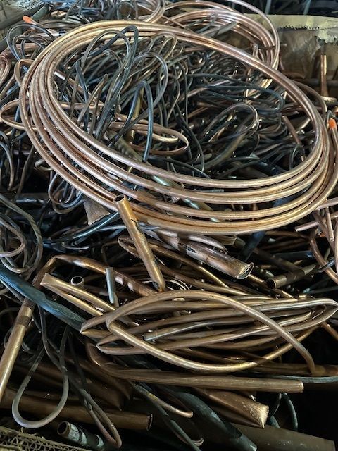 A pile of copper wire is sitting on top of each other on a table.