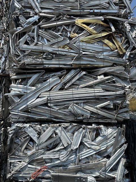 A pile of scrap metal is stacked on top of each other.