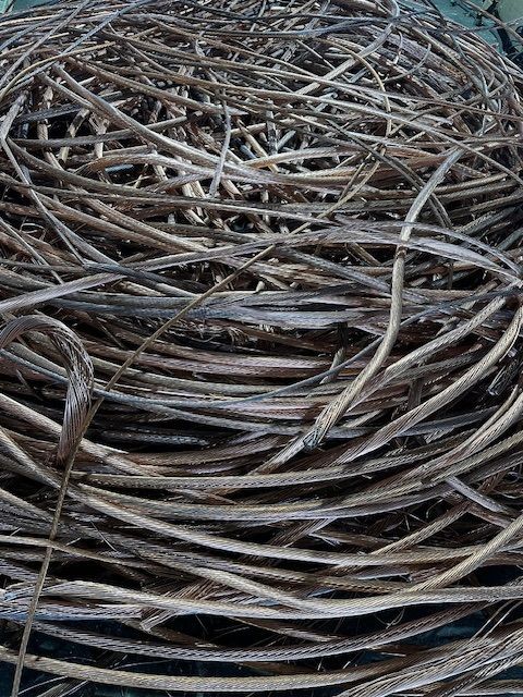 A pile of big wires sitting on top of each other on a table.