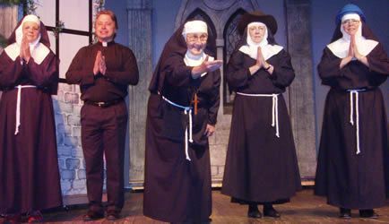 A group of nuns standing next to each other on a stage