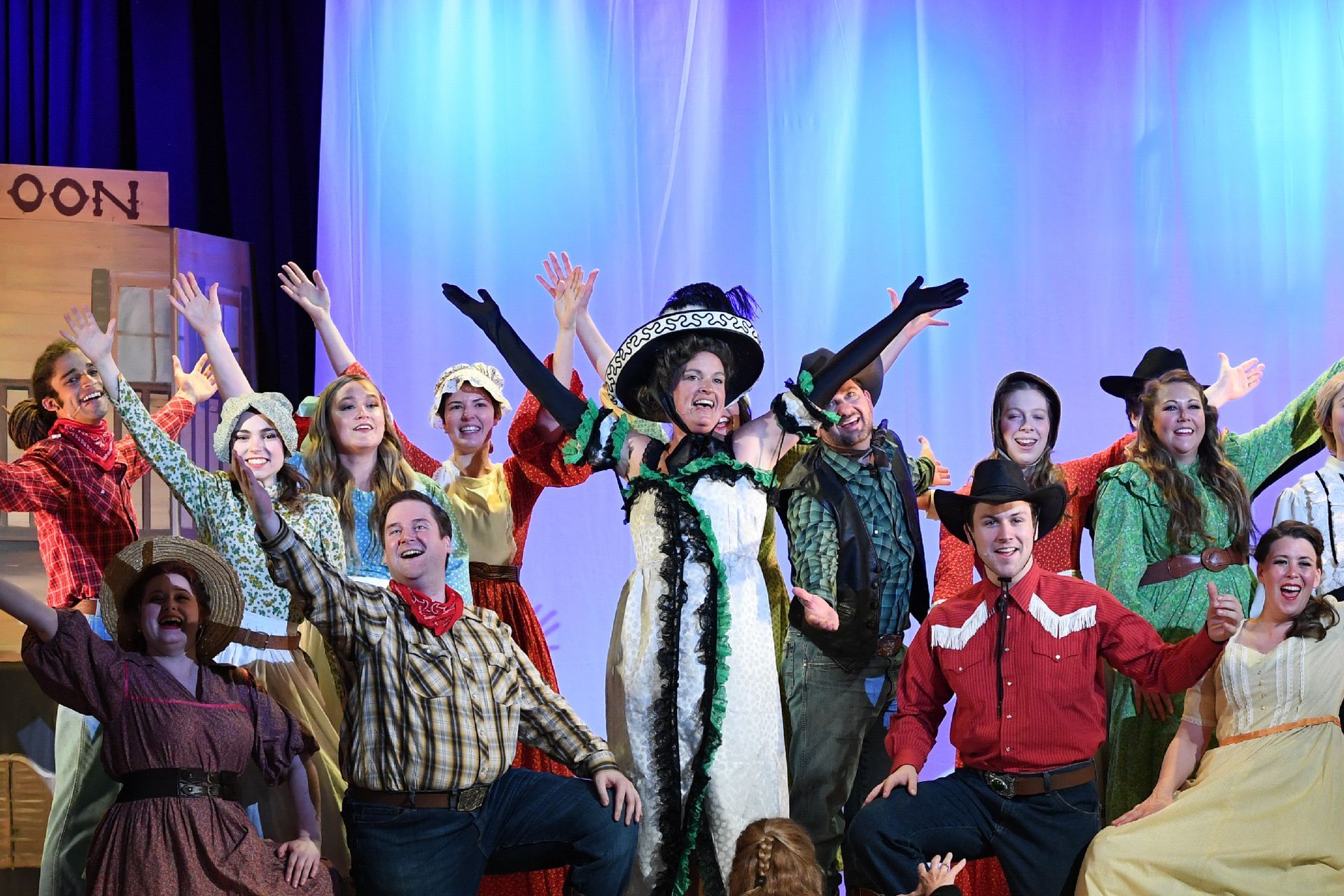 A group of people are posing for a picture on a stage.