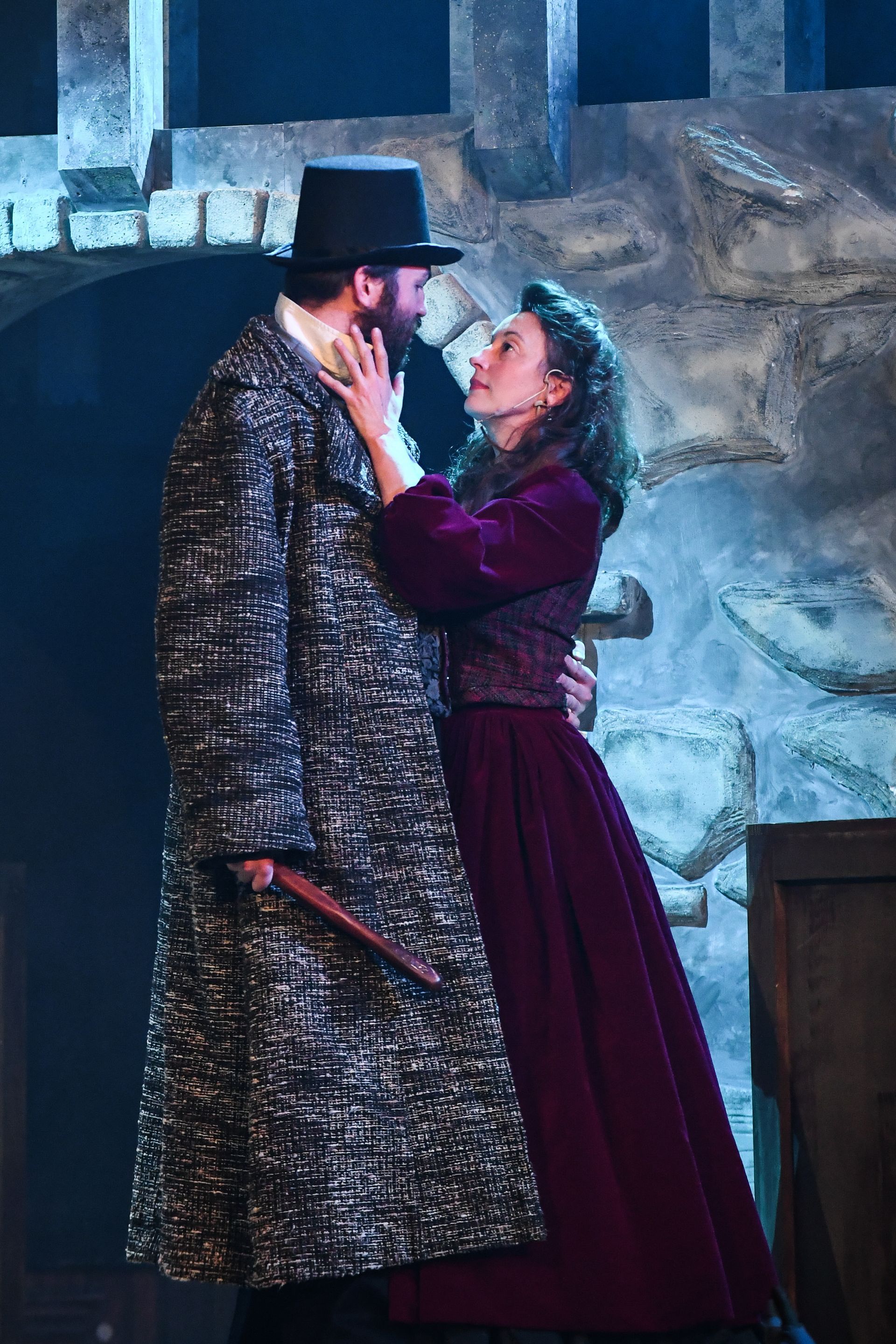 A man and a woman are standing next to each other on a stage.