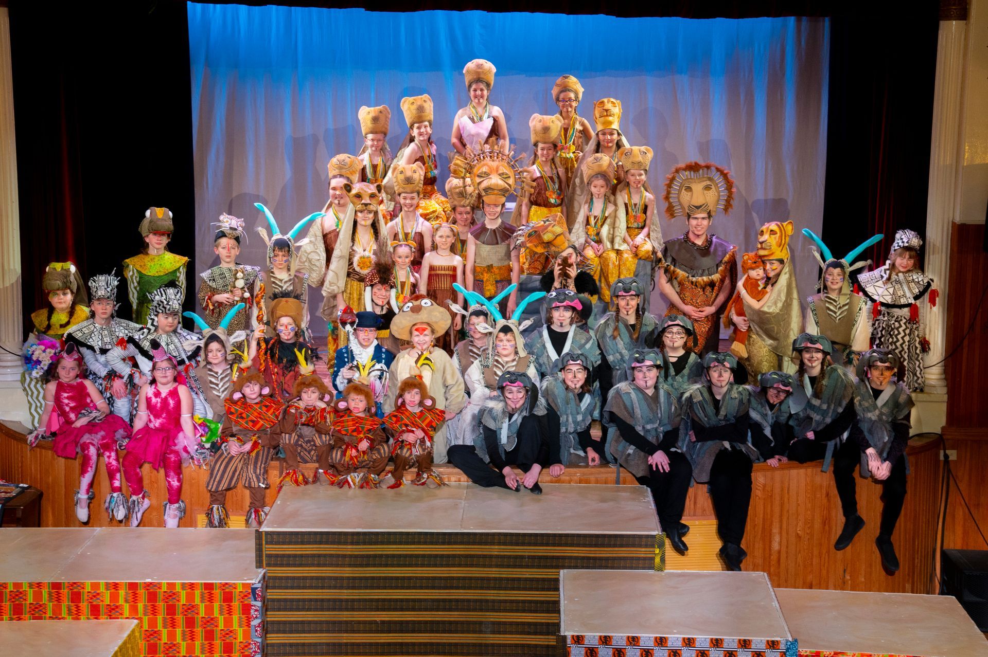 A large group of people are posing for a picture on a stage.