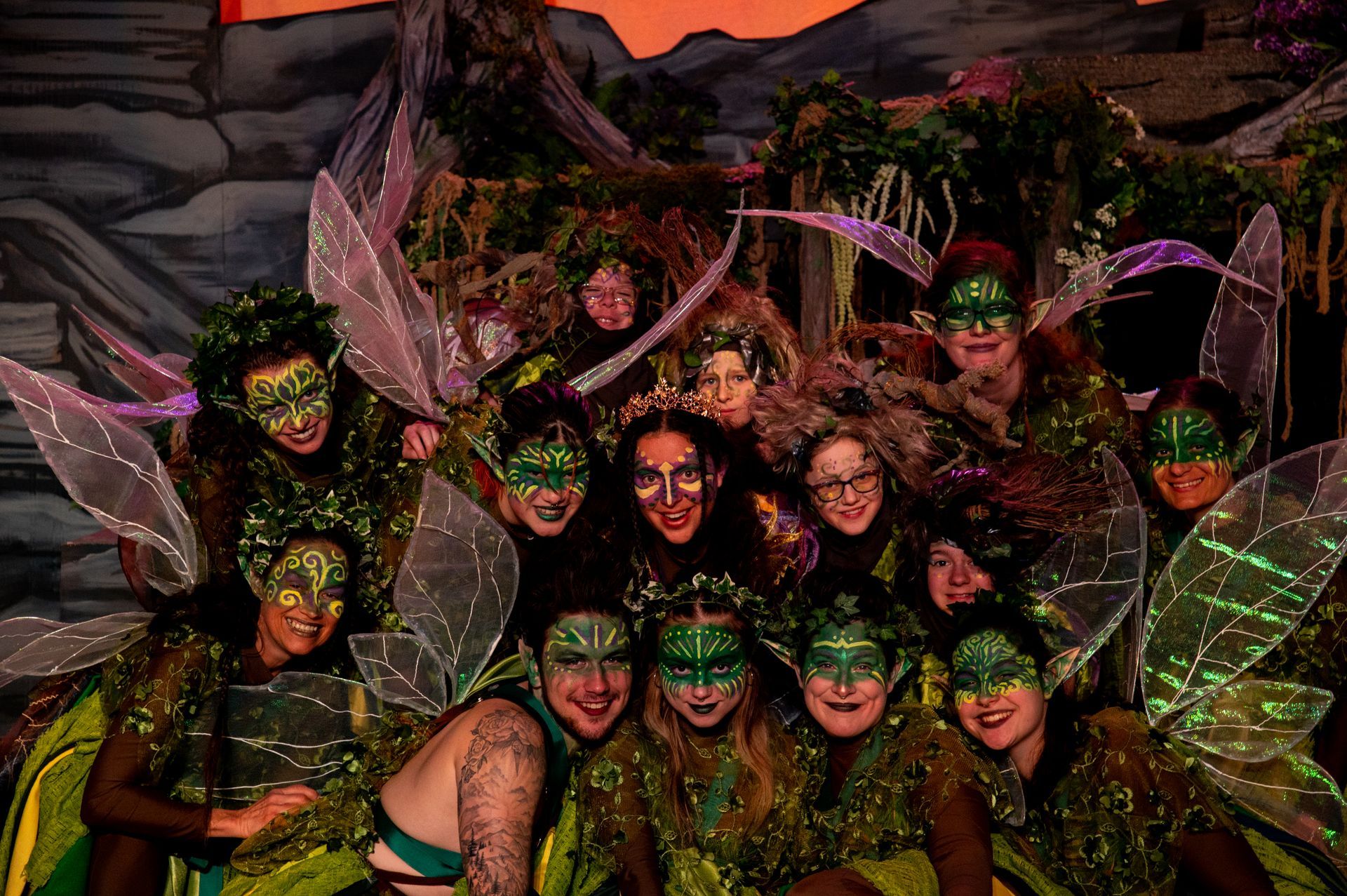 A group of people dressed as fairies are posing for a picture